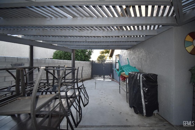 view of patio featuring fence, a pergola, and outdoor dining space