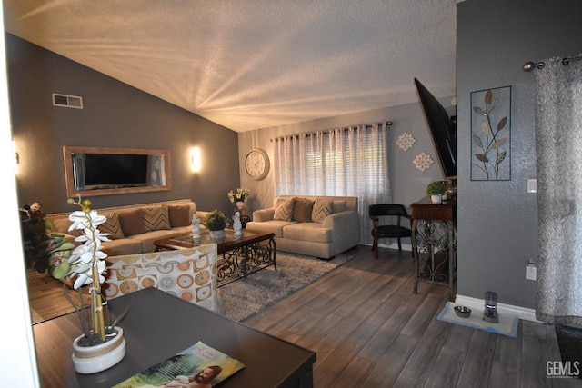 living room featuring baseboards, visible vents, wood finished floors, vaulted ceiling, and a textured ceiling