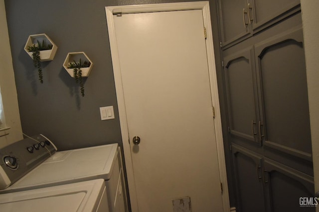 laundry room with separate washer and dryer and cabinet space