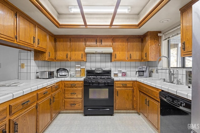 kitchen featuring light floors, brown cabinets, under cabinet range hood, and black appliances