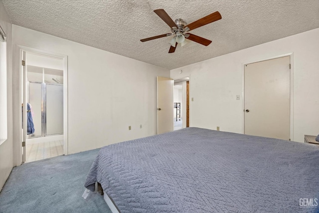 unfurnished bedroom featuring carpet, ceiling fan, a textured ceiling, and ensuite bathroom