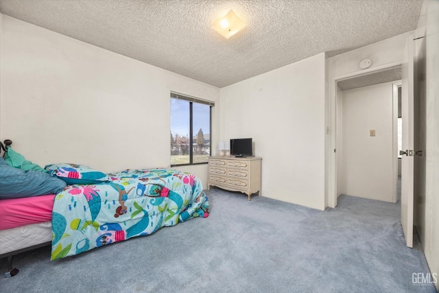 carpeted bedroom with a textured ceiling