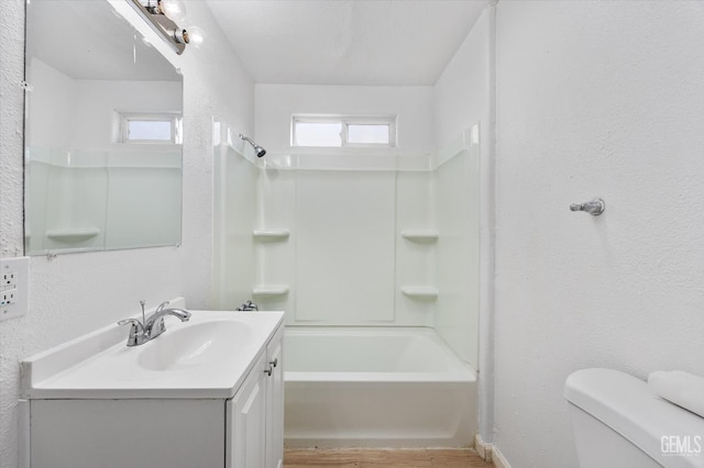 914 P St, Bakersfield, CA 93304 - full bathroom featuring vanity, bathing tub / shower combination, wood finished floors, and a textured wall