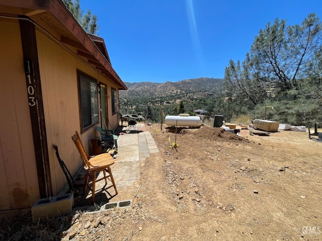 view of yard with a mountain view and a patio area