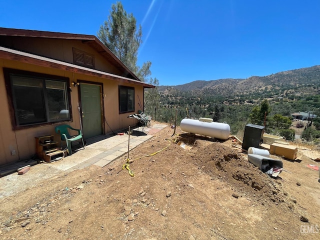 view of yard with a mountain view and a patio