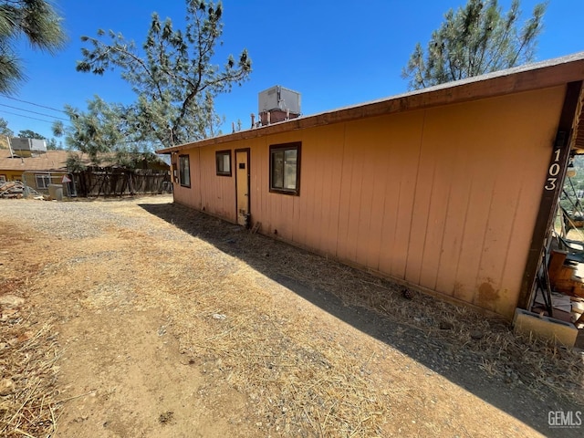 view of side of home with central air condition unit