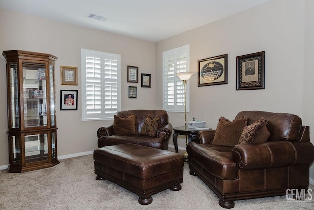 living room featuring carpet floors, visible vents, and baseboards
