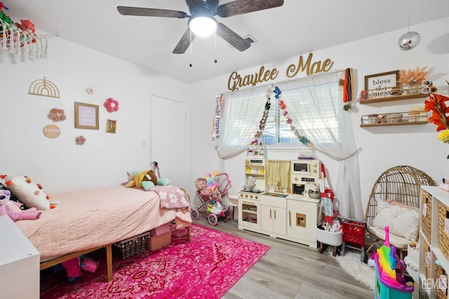 bedroom featuring a ceiling fan and wood finished floors