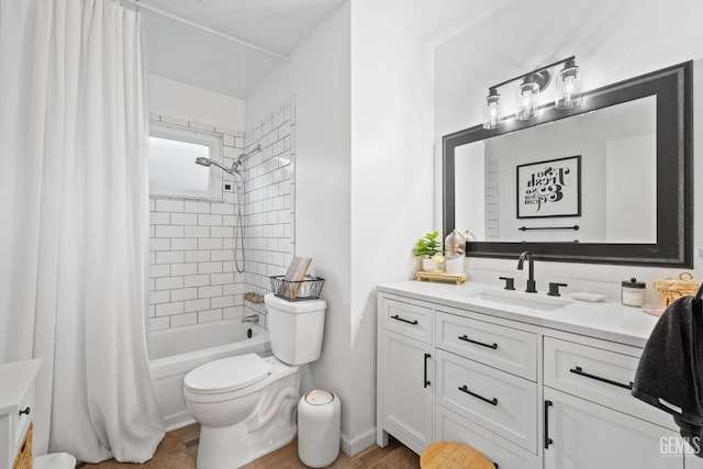 bathroom with shower / tub combo, vanity, and toilet