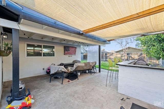 view of patio / terrace featuring an outdoor hangout area, fence, and outdoor dry bar