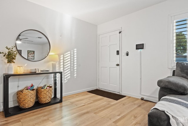 entryway with wood finished floors and baseboards