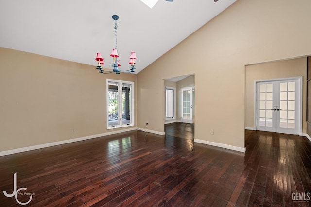 empty room featuring high vaulted ceiling, baseboards, dark wood finished floors, and french doors