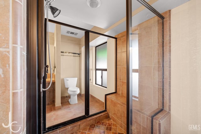 full bathroom featuring toilet, a shower stall, and visible vents