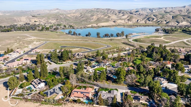 drone / aerial view with a residential view and a water and mountain view