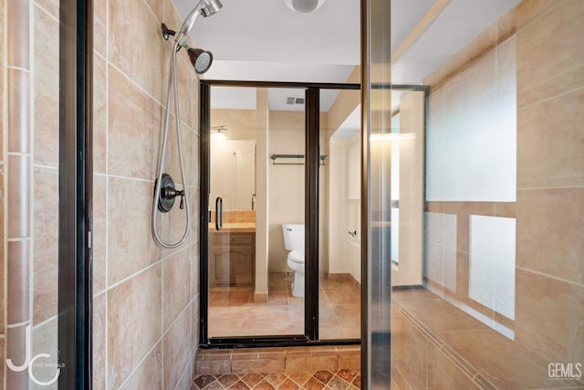 bathroom with toilet, a stall shower, and visible vents