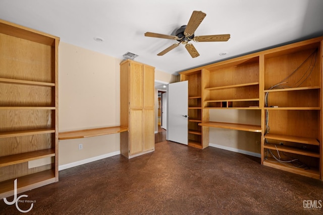 interior space featuring baseboards, concrete floors, visible vents, and built in study area