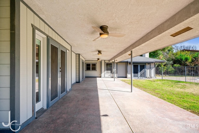 view of patio with ceiling fan and fence