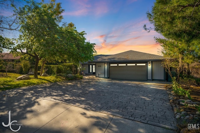 view of front of house featuring decorative driveway and an attached garage