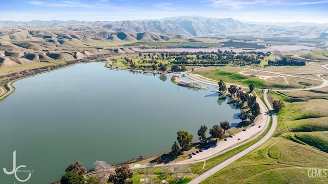 birds eye view of property featuring a water and mountain view