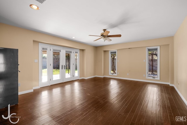 unfurnished living room with recessed lighting, baseboards, dark wood-type flooring, and french doors