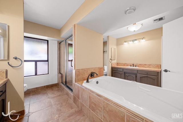 bathroom with tile patterned flooring, toilet, visible vents, vanity, and a shower stall