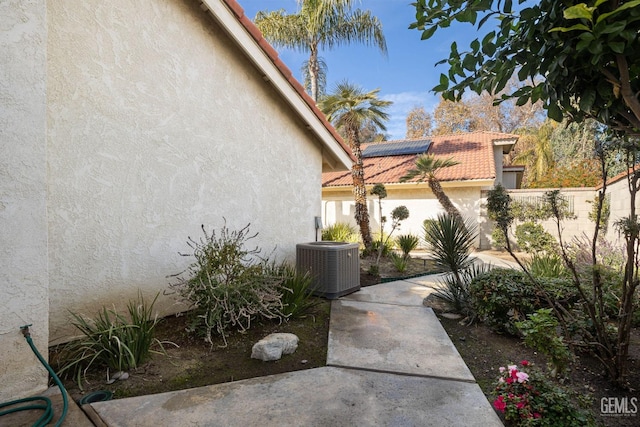 exterior space featuring solar panels and central air condition unit