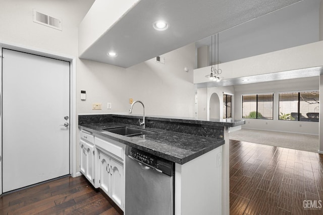 kitchen with dishwasher, sink, white cabinets, hanging light fixtures, and kitchen peninsula