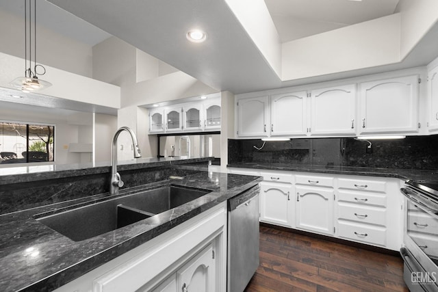 kitchen with white cabinetry, appliances with stainless steel finishes, sink, and decorative backsplash