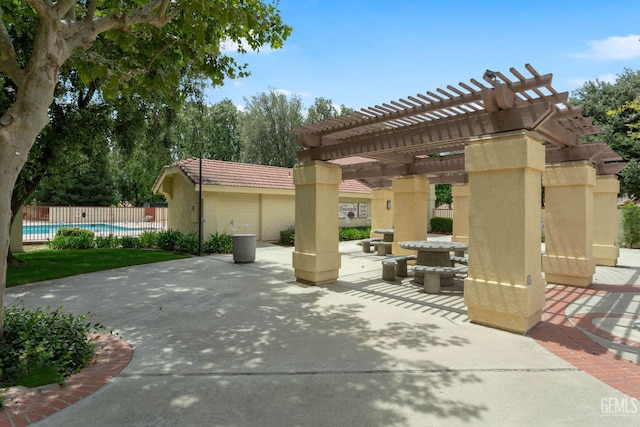 view of patio / terrace featuring a fenced in pool and a pergola