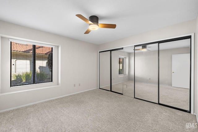 unfurnished bedroom featuring ceiling fan, light carpet, and a closet