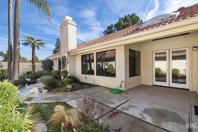 rear view of property featuring a patio and french doors