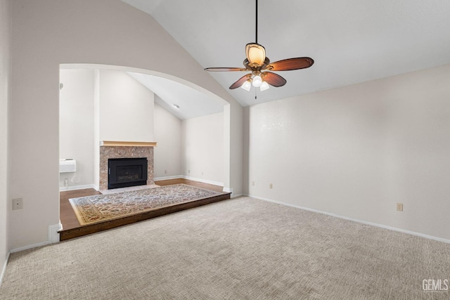 unfurnished living room with vaulted ceiling, carpet floors, and ceiling fan