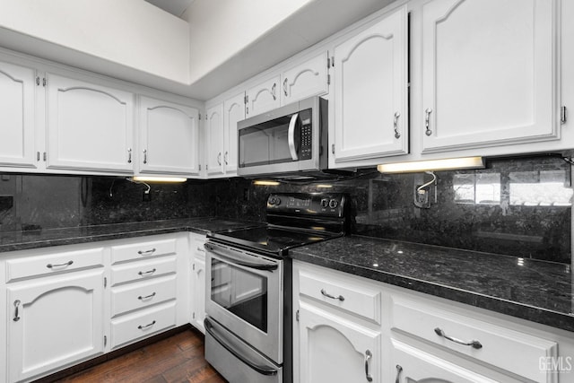 kitchen with stainless steel appliances, tasteful backsplash, and white cabinets