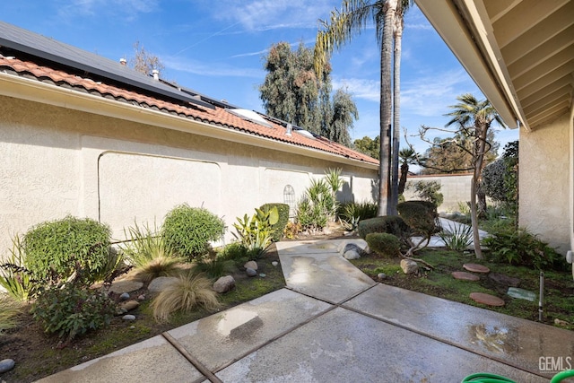 exterior space with a patio area and solar panels