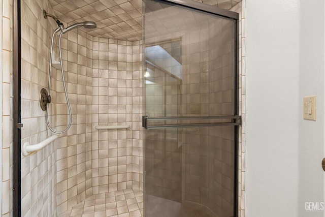 bathroom featuring a shower with door