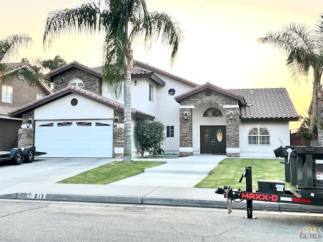 view of front of property with a lawn and a garage