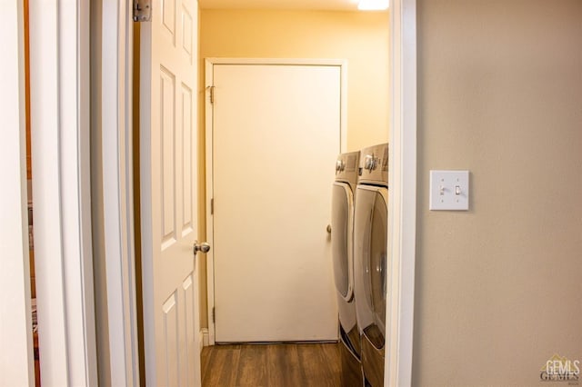 washroom with washer and clothes dryer and dark wood-type flooring