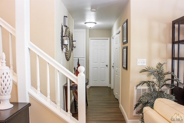 corridor with hardwood / wood-style flooring