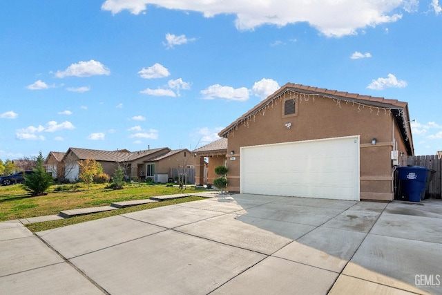 single story home featuring a garage, a residential view, driveway, and stucco siding