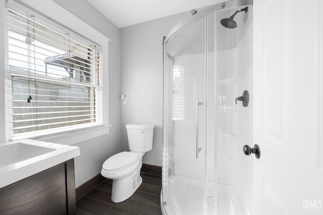 bathroom with vanity, toilet, and an enclosed shower