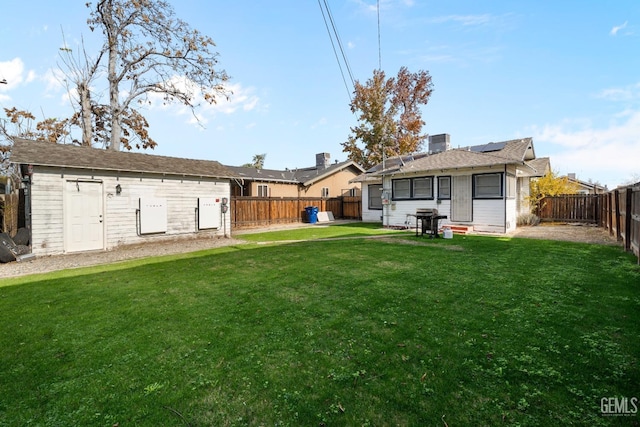 rear view of house with a yard, central AC unit, and solar panels