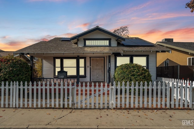 bungalow-style house featuring a porch and solar panels