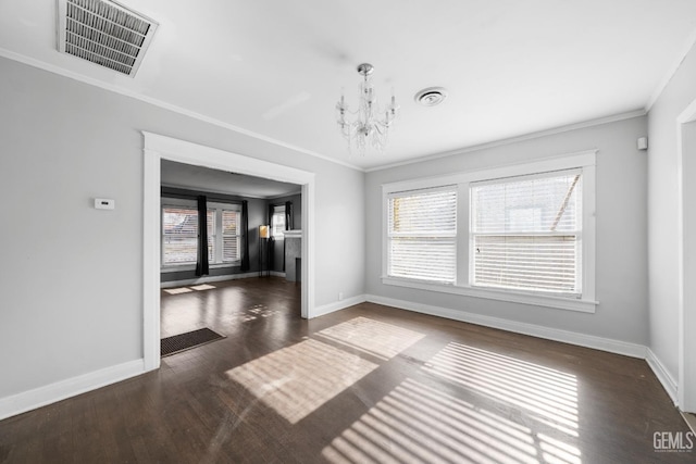 interior space featuring dark hardwood / wood-style flooring, an inviting chandelier, and ornamental molding