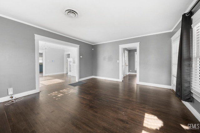 spare room featuring dark hardwood / wood-style floors and crown molding