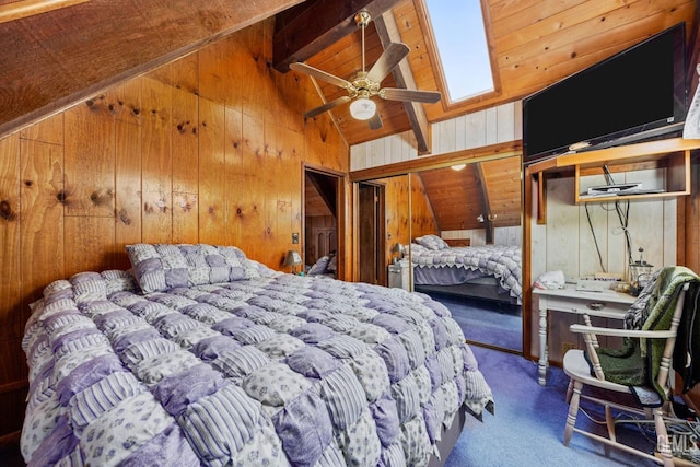 carpeted bedroom featuring lofted ceiling with skylight and wood walls