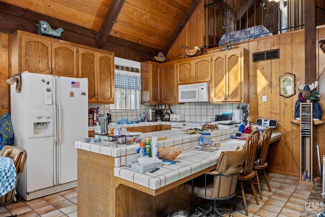 kitchen with lofted ceiling with beams, white appliances, wood ceiling, tile counters, and visible vents