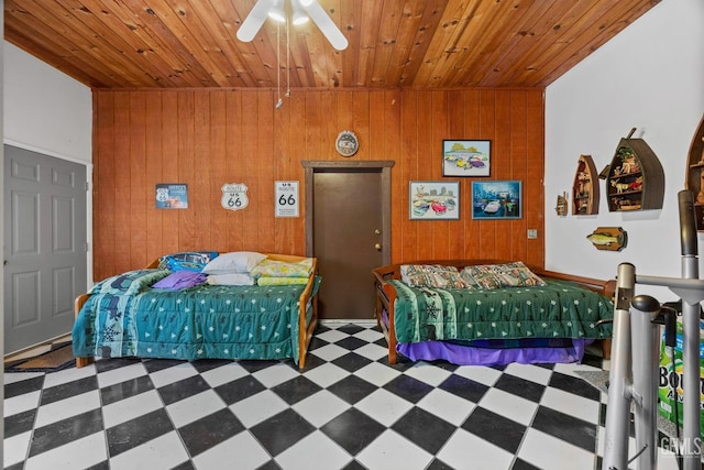bedroom with tile patterned floors, wood walls, and wooden ceiling