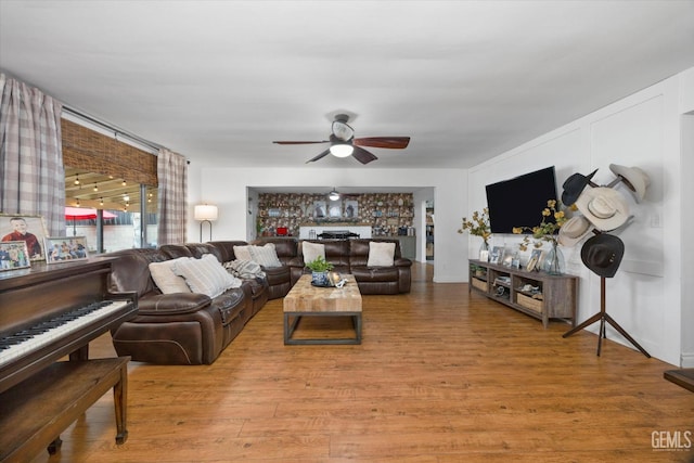 living room featuring wood finished floors and a ceiling fan