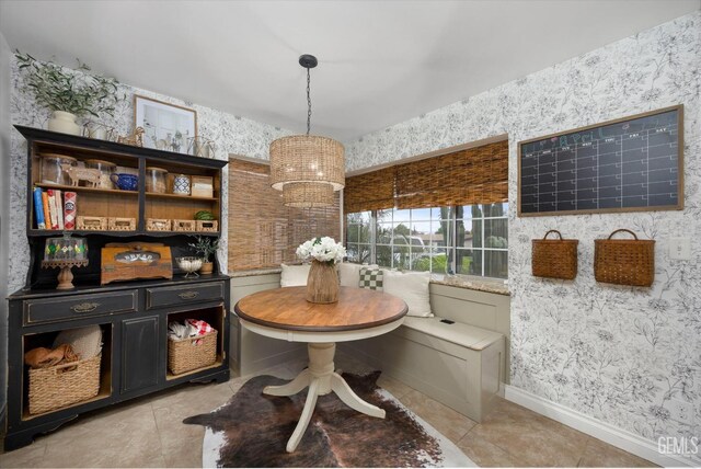 dining area featuring wallpapered walls, baseboards, and light tile patterned flooring