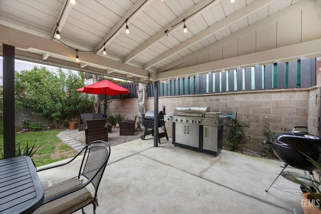 view of patio with grilling area and a fenced backyard
